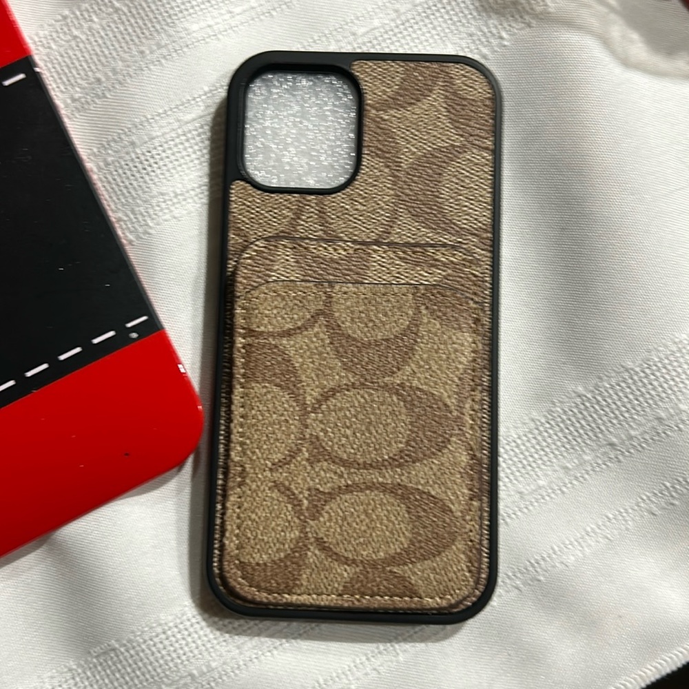 Brand new coach iPhone 13 14. It has a place for credit cards as seen in photo